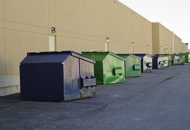 construction workers toss wood scraps into a dumpster in Fernandina Beach, FL